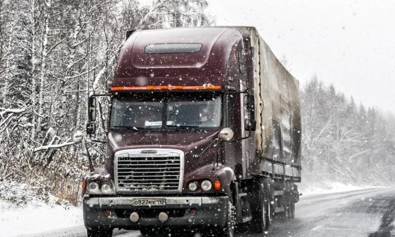 truck driving through snow